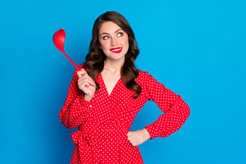 Sticker - Photo of young beautiful positive smiling dreamy girl hold ladle look copyspace bite lips isolated on blue color background