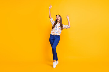 Full length photo portrait of fit woman dancing with closed eyes isolated on vivid yellow colored background