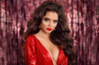 © Victoria Andreas - Beautiful brunette in red dress with Healthy wavy hair. Glamour Makeup. Fashion Beauty Girl Isolated on bright bokeh party Christmas Background.