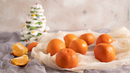 Christmas concept with tangerines. Juicy orange clementines. Christmas decor with sweet Xmas tree. New year concept