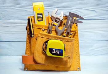 Wall Mural - Set of tools in suede bag for master builders on blue boards