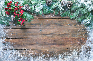 Wall Mural - christmas and new year background with fir branches and snowfall on wooden board