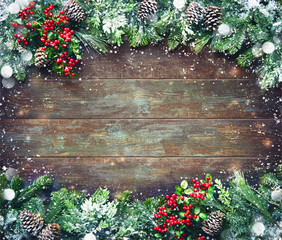 Wall Mural - christmas and new year background with fir branches and snowfall on dark wooden board