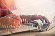 © peshkova - Double exposure of businesswoman hands typing on computer and forex chart hologram drawing. Financial analysis concept.