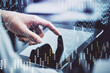 © peshkova - Multi exposure of man's hands holding and using a phone and financial chart drawing. Market analysis concept.