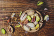 Salty pistachio snack on wooden background, directly above