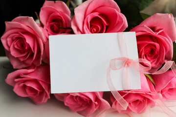 romantic composition. bouquet of pink roses and gift box on white background