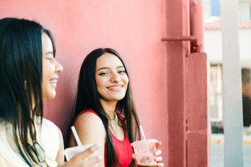 portrait of two cheerful young women smiling while talking. friendship and dental health concept.