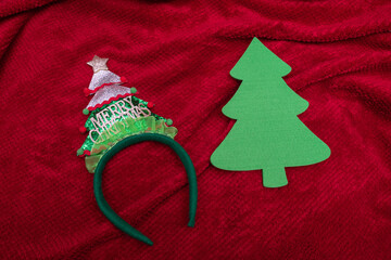 Hairband, accessory for Christmas celebration and christmas tree on red background