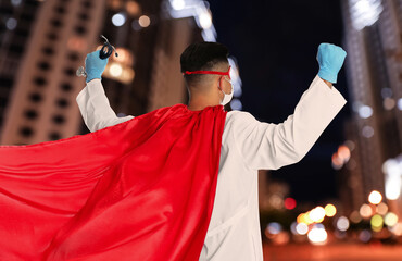 Canvas Print - Doctor dressed as superhero on night city background. Medical workers fighting with dangerous diseases