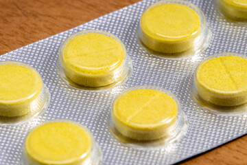 Wall Mural - yellow tablets in a close-up blister. medical drug