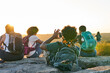 © Mhandy/Creative Flame - Friends enjoying weekend getaway on mountain top at sunset