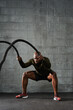 © B. Alyssa Trofort/Creative Flame - Man doing battle rope training exercises