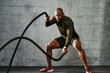 © B. Alyssa Trofort/Creative Flame - Man doing battle rope training exercises