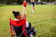 © B. Alyssa Trofort/Creative Flame - Supportive mother cheers for daughters' team
