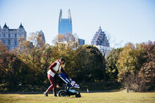 Mother And Baby Walking In Park