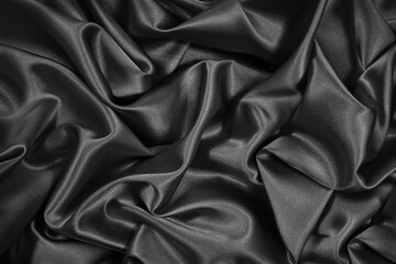 Wall Mural - Black silk satin. Black shiny fabric background. Beautiful bright abstract background.