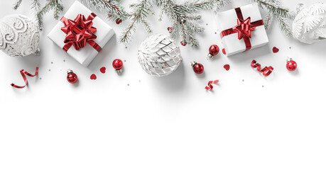 merry christmas card made of gift boxes, fir branches, red and silver decoration, sparkles and confe