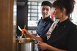 © Wavebreak Media - Two diverse male and female chefs in kitchen