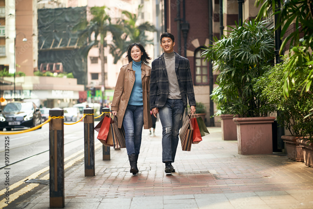 happy young asian couple walking shopping on street Stock Photo | Adobe ...