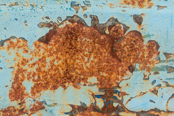 Wall Mural - Brown and orange rust on old blue metal.