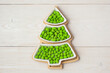 Christmas sweets. Candy in a plate in the shape of a Christmas tree on a wooden background. Place for your text. View from above. Candy bar.