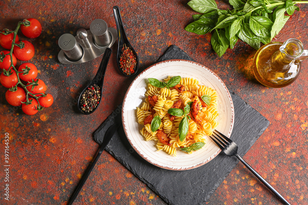 Plate of tasty pasta with chicken on table