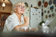© Viacheslav Yakobchuk - Lovely senior woman pondering about answers for test at home