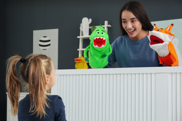 Canvas Print - Mother performing puppet show for her daughter at home