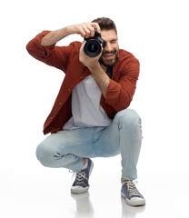 Wall Mural - photography, profession and people and concept - happy smiling man or photographer with digital camera over white background