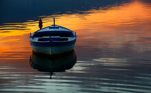 A Boat Moored In The Reflection Of The Sky