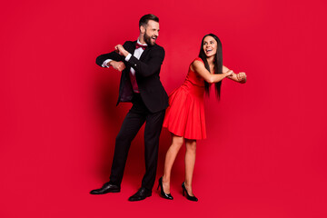 Poster - Full size portrait of carefree cheerful lady guy dance chilling good mood isolated on red color background