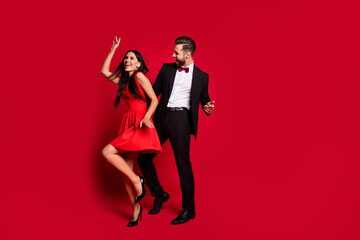 Poster - Full size photo of two persons enjoy dance clubbing lady wear stilettos isolated on red color background