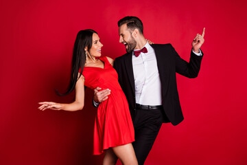profile photo of funny optimistic couple dancing wear suit dress isolated on red color background