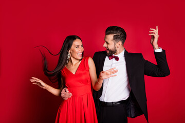 Poster - Photo of funny optimistic couple dancing wear suit dress isolated on red color background