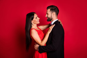 Poster - Profile photo of optimistic cute couple dance wear suit dress isolated on red color background