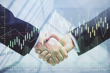 Double exposure of forex graph hologram and handshake of two men. Stock market concept.