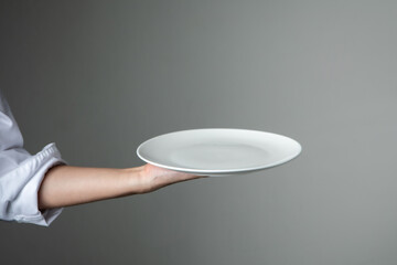 chef present food with white empty plate