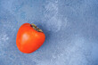 Persimmon on blue concrete background. Recipe, vitamin, nutrition concept. Copy space, close-up, top view, flat lay