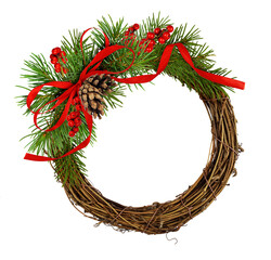 dry brown rattan wreath and christmass arrngement with green spruce twigs, red berries, cones and ri