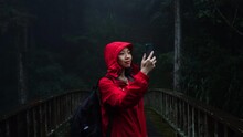 Traveler Taking Picture Of Rainy Forest