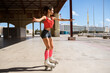 © Javier Ballester/ADDICTIVE STOCK - Concentrated female roller skating on sports ground on sunny day in city