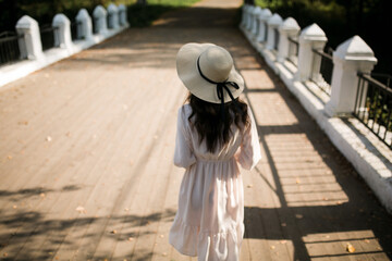 girl walking in a hat in summer 