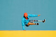© VISTA by Westend61 - Young disabled man doing handstand against multi colored wall