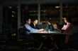 © David Prado/Stocksy - Cheerful young group of colleagues working late in office