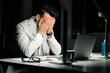 © David Prado/Stocksy - Overworked executive male employee in office