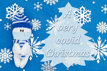 Wall Mural - A very Covid Christmas message with a snowman wearing a mask