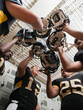 © Erik Isakson/Blend Images - Football players celebrating in locker room