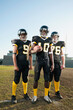 © Erik Isakson/Blend Images - Football players standing on football field