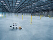 © Erik Isakson/Blend Images - Architects using laptop and blueprint in empty warehouse